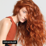Person with long, wavy red hair wearing a rust-colored sleeveless top on a light gray background, with Keracolor logo.