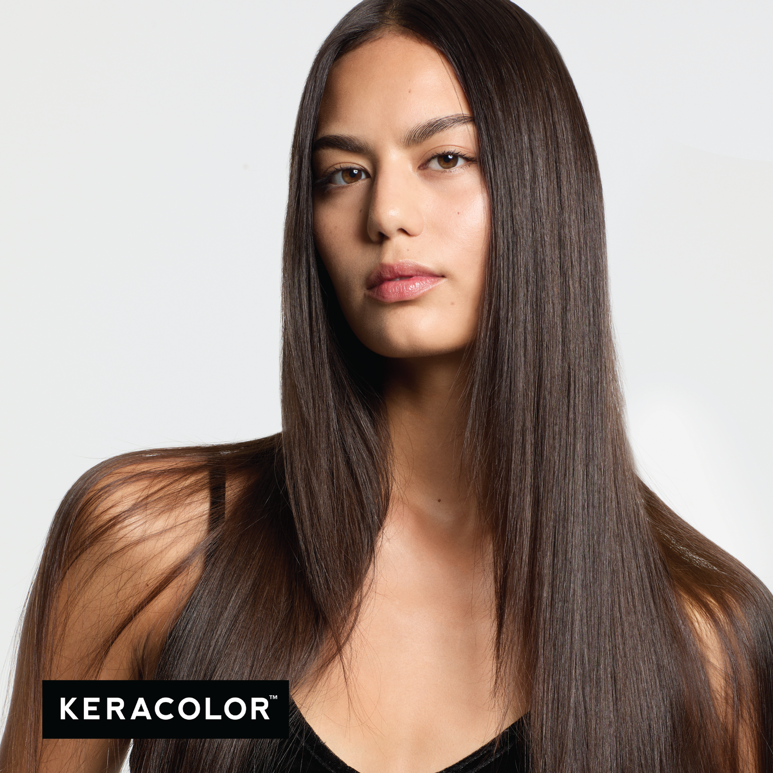 Woman with long, straight hair on a white background with Keracolor logo.