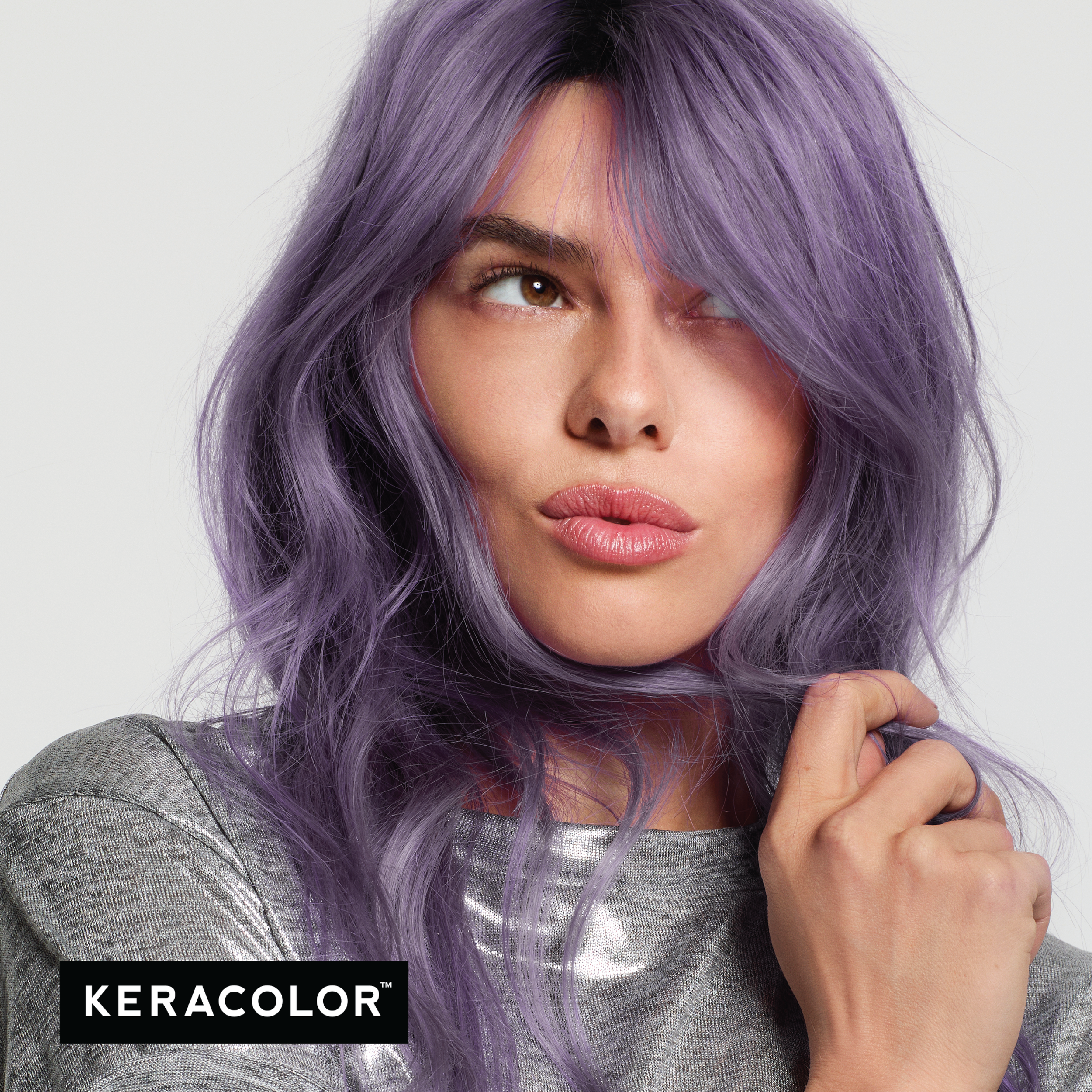 Woman with lavender hair wearing a silver top, with Keracolor logo.