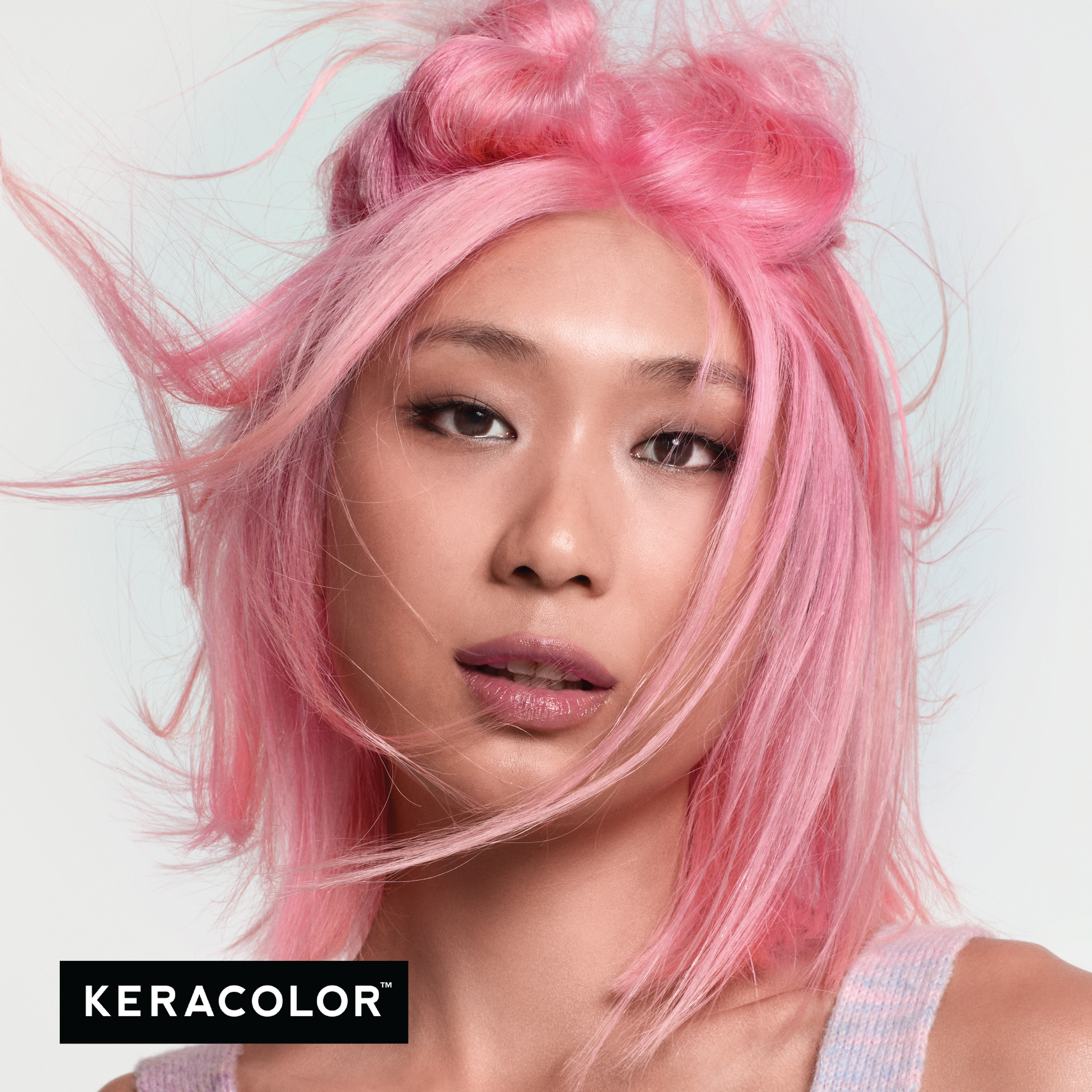 Person with pink hair against a light background, featuring the Keracolor logo.