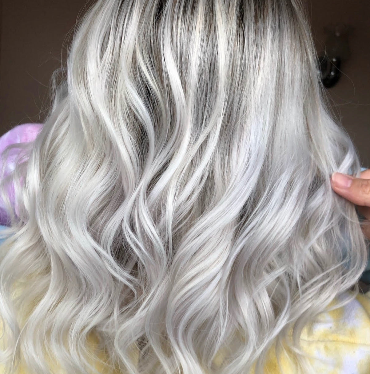 A candid image of a women with bleached hair treated with Violet toning drops