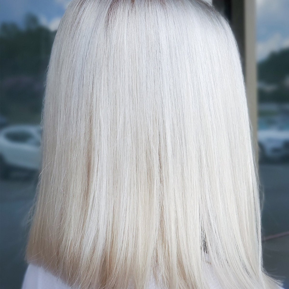 A candid image of a woman with platinum colored hair maintained by Color+ treatment platinum.